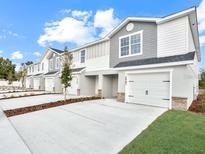 New construction townhomes feature a modern design, private garages, and well-maintained landscaping at 2745 Walden Town Cir, Plant City, FL 33566