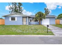 Charming single-story home with a well-maintained lawn and a lovely palm tree in the front yard at 2306 33Rd W St, Bradenton, FL 34205