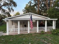 Charming single-story home featuring a welcoming front porch with white picket fence, perfect for enjoying the outdoors at 4818 Huron St, Zephyrhills, FL 33541
