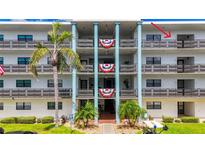 Exterior of building showcasing balconies with patriotic decorations at 5980 80Th N St # 408, St Petersburg, FL 33709