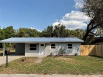 Charming single-story home with a new metal roof, a carport, and a freshly landscaped yard at 14002 Morgan St, Dade City, FL 33525