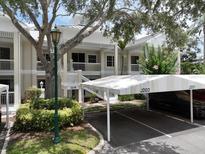 Inviting condo exterior with covered parking and lush landscaping in a well-maintained community at 3608 54Th W Dr # 202, Bradenton, FL 34210