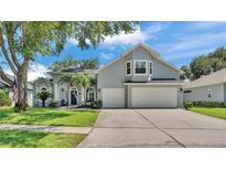 Charming home with a three-car garage, manicured lawn, and beautiful landscaping at 3911 Smoke Rise Ct, Valrico, FL 33594