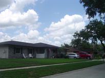Charming single-story home with a well-maintained lawn and tidy landscaping features at 704 Queens Ct, Seffner, FL 33584