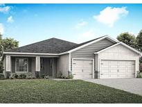 Charming single-story home with gray siding, well-manicured lawn, and a two-car garage at 2422 White Ladyfish Rd, Wimauma, FL 33598