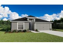 Charming single-story home with a manicured lawn, stone accents, and a two-car garage at 2572 58Th E Cir, Palmetto, FL 34221