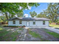 Charming single-story home featuring a well-maintained front yard, inviting entrance, and natural surroundings at 2633 Keysville Dr, Lithia, FL 33547