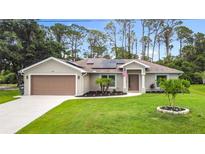 Charming single-story home with a well-maintained lawn and solar panels, enhancing its curb appeal at 4592 Crabapple Ave, North Port, FL 34287