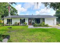 Charming single-story home featuring a well-manicured lawn, brick facade, and inviting front porch at 4616 Edwards Rd, Plant City, FL 33567