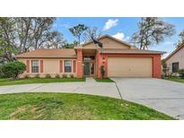 Charming single-Gathering home featuring a well-maintained lawn and attached two car garage at 8050 Eacon Ct, Hudson, FL 34667