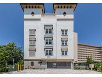 Condo building exterior, showcasing a modern design and gated parking at 225 The Esplanade N. # 401, Venice, FL 34285