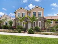 Two-story house with stone accents and landscaping at 934 E Venice Ave, Venice, FL 34285