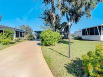 Mobile home exterior with paved driveway and landscaping at 5216 Palena Blvd, North Port, FL 34287