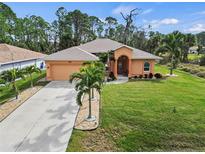 Attractive single-story house with a well-manicured lawn and palm trees at 4288 Platt St, North Port, FL 34286