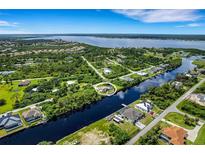 Aerial view of waterfront property with canal access at 13208 Windcrest Dr, Port Charlotte, FL 33953