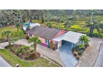 Aerial view of charming pink house with carport at 7037 Duke St, Englewood, FL 34224