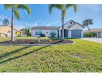 Newly renovated home with a well-manicured lawn at 18091 Eau Gallie Cir, Port Charlotte, FL 33948