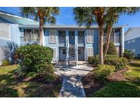 Two-story building with light blue exterior and staircase at 454 Cerromar Rd # 275, Venice, FL 34293