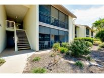 Condo exterior with stairs and screened-in patio at 744 White Pine Tree Rd # 103, Venice, FL 34285
