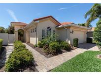 Single story home with tile roof, landscaped yard, and walkway at 205 Mestre Pl, North Venice, FL 34275