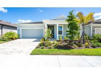 Charming light blue house with a well-manicured lawn at 20450 Bandera Pl, Venice, FL 34293