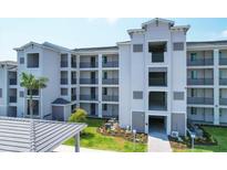 Modern apartment building with balconies and landscaping at 12240 Wellen Golf St # 202, Venice, FL 34293