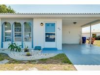 Front view of a single story home with carport and landscaped yard at 472 Circlewood Dr # L9, Venice, FL 34293