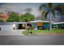 Ranch-style home with attached garage and landscaped lawn at 1350 Stafford Ln # 1422, Sarasota, FL 34232
