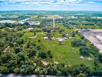 Aerial view of property showing a large home and surrounding land at 1109 Twin Laurel Blvd, Nokomis, FL 34275