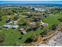 Aerial view of a large property with multiple buildings and lush green fields at 1107 Twin Laurel Blvd, Nokomis, FL 34275