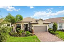 Single-Gathering home with a two-car garage and nicely landscaped front yard at 13360 Esposito St, Venice, FL 34293