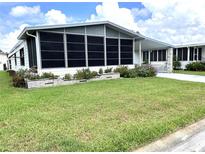 Single-wide mobile home with large screened porch at 257 Palm Harbor Dr, North Port, FL 34287