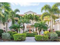 Inviting condo complex with lush tropical landscaping and well-maintained grounds at 4240 Central Sarasota Pkwy # 616, Sarasota, FL 34238