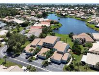 Aerial view of a waterfront community with lush landscaping at 600 Carriage House Ln # 104, Nokomis, FL 34275