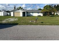 Ranch-style home with carport and mature landscaping at 3485 Roslyn Rd, Venice, FL 34293