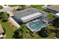 Aerial view of home with pool and lush landscaping at 221 Malvern Dr, Venice, FL 34293