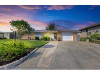 Inviting single-story home with landscaped yard and attached garage at 703 Portia N St, Nokomis, FL 34275
