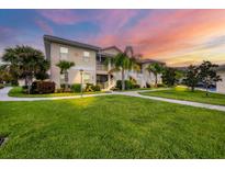 Condo building exterior with landscaping and walkway at 200 Gardens Edge Dr # 213, Venice, FL 34285