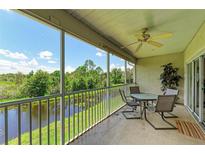 Spacious screened balcony overlooking a peaceful canal; perfect for outdoor relaxation at 872 Saranac Lake Dr # 202, Venice, FL 34292
