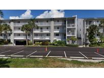 Condo building with parking and landscaping at 1401 S Mccall Rd # 107B, Englewood, FL 34223