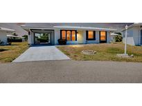 White and gray single-story house with carport and landscaping at 475 Circlewood Dr # O18, Venice, FL 34293