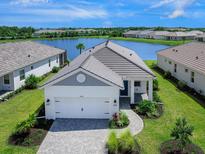 Single-story house with lake view and two-car garage at 18260 Vizcaya Ct, Venice, FL 34293