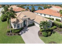 Luxury house with a tile roof and a large driveway at 145 Montelluna Dr, North Venice, FL 34275