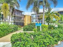 Two-story condo building with tropical landscaping at 618 Bird Bay S Dr # 202, Venice, FL 34285