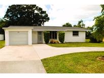 Ranch-style home with a single car garage at 205 Venice East Blvd, Venice, FL 34293