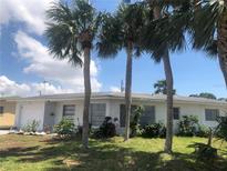 Ranch style home with mature palm trees in the front yard at 268 Shamrock Blvd, Venice, FL 34293