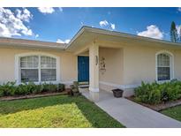 House exterior showcasing a blue front door, landscaping and walkway at 511 Porpoise Rd, Venice, FL 34293