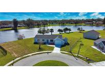 Aerial view of a house on a cul-de-sac near a lake at 5032 Koli Ct, North Port, FL 34287