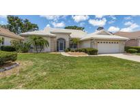 Single story home with tile roof and two car garage at 1136 Highland Greens Dr, Venice, FL 34285