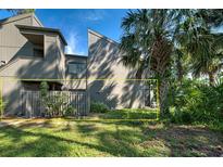 Private backyard with a wooden fence and lush green plants at 201 Woodland Dr # 201, Osprey, FL 34229